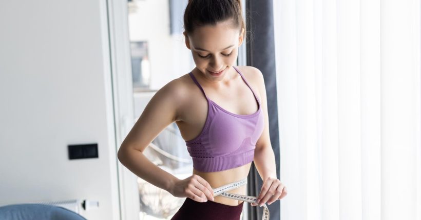 sporty-young-woman-measure-around-her-body